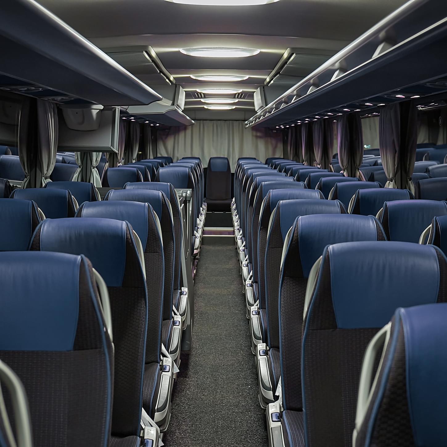 Comfortable and well-maintained coach bus interior with reclining seats
